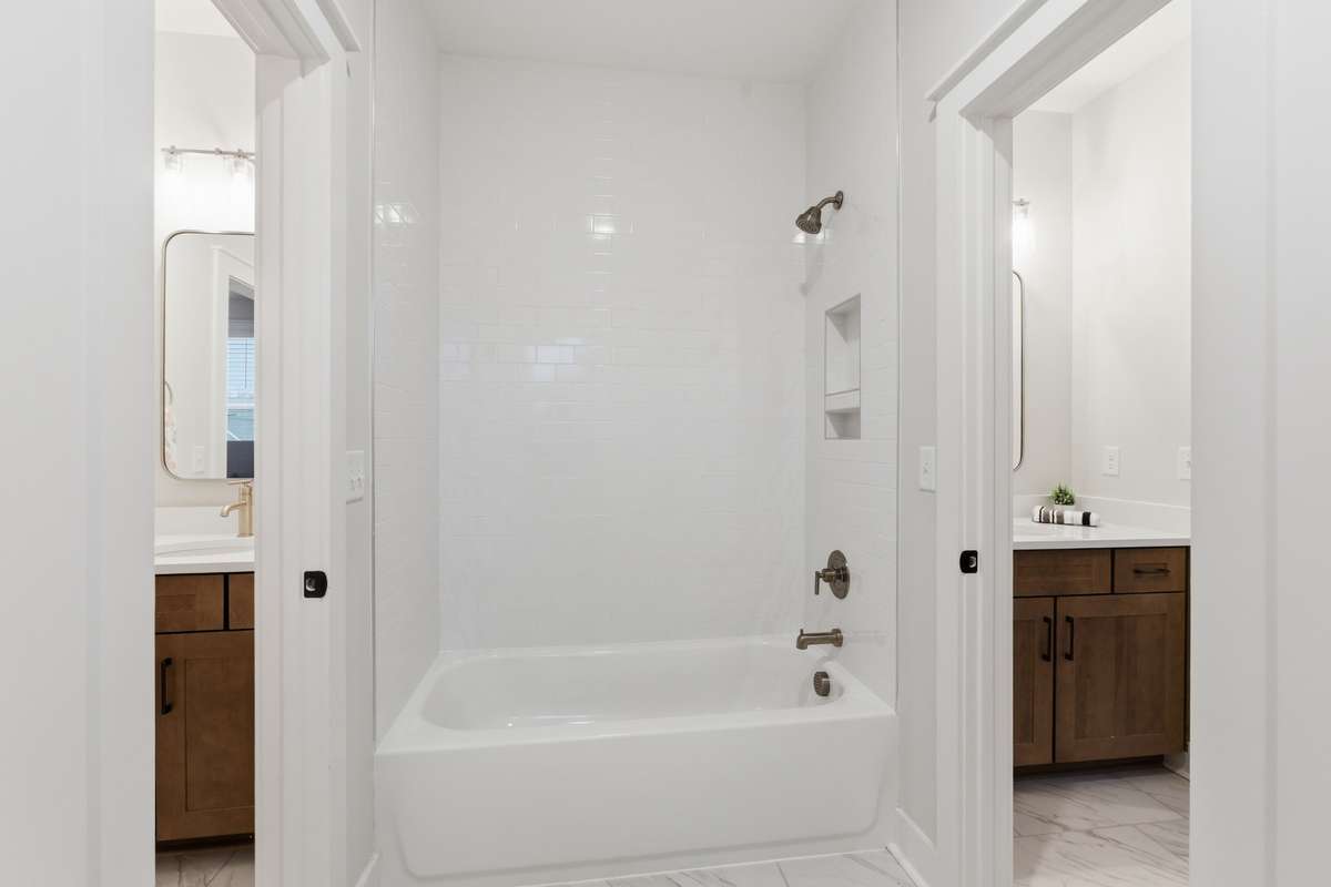 Upstairs, you will find a Jack-and-Jill bathroom that is the perfect mix for the space!