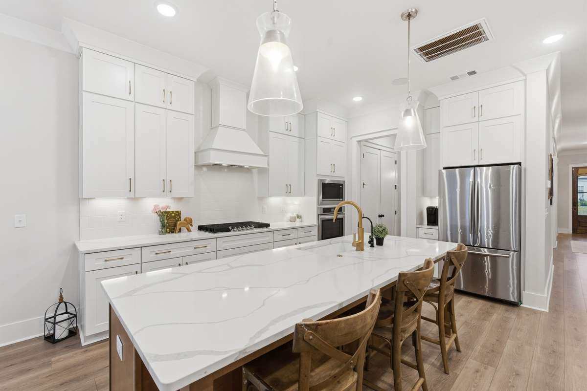Accented with amazing fixtures, this space is the perfect spot to host. All SS appliances, high cabinetry, and ample counterspace make it effortlessly simple to keep your kitchen neat and tidy.