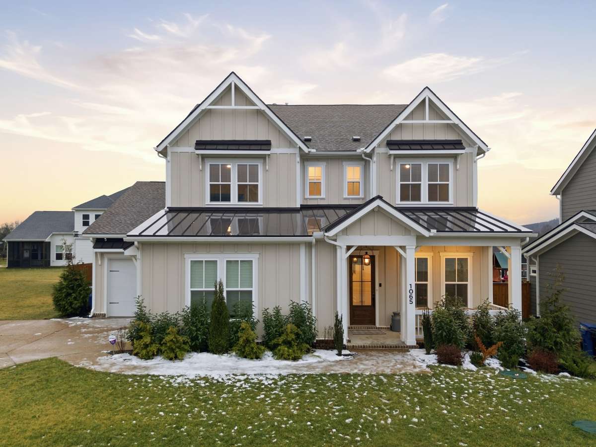 The home's modern farmhouse architecture, featuring contrasting dark trim, multiple gables, and board-and-batten siding are just some of the amazing features of this luxury home.