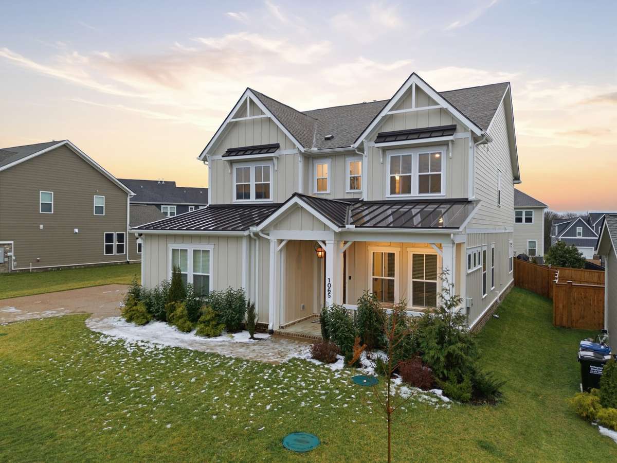The home's modern farmhouse architecture, featuring contrasting dark trim, multiple gables, and board-and-batten siding are just some of the amazing features of this luxury home.