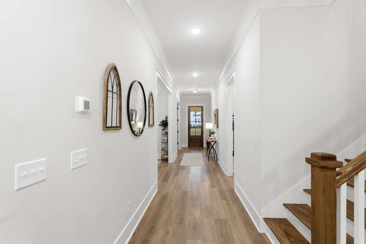 Beautiful wood flooring paired with a fresh and light color scheme add a peaceful touch to the space upon entry. Stair to the right take you to the upstairs bedrooms, bathrooms, and bonus room.