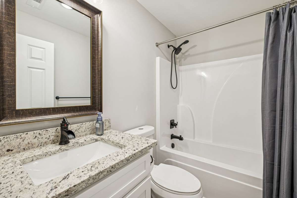 guest bathroom with granite countertops