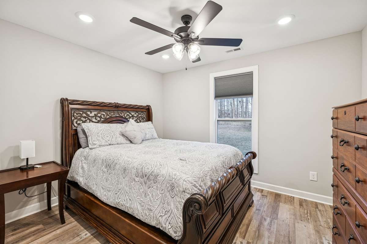secondary bedroom with extra-large closet and ceiling fan