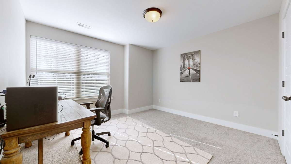 Third bedroom makes a great office with large window. Faux wood blinds included.