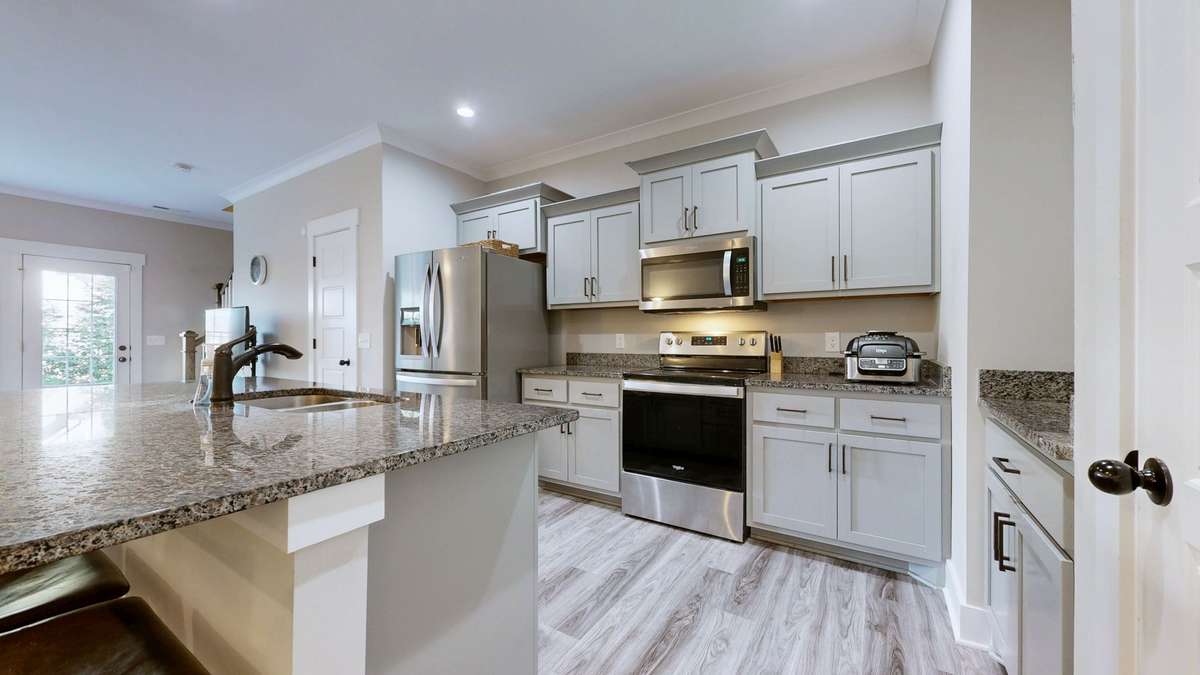 Check out this fabulous kitchen with granite, stainless appliances, and extra large work island.