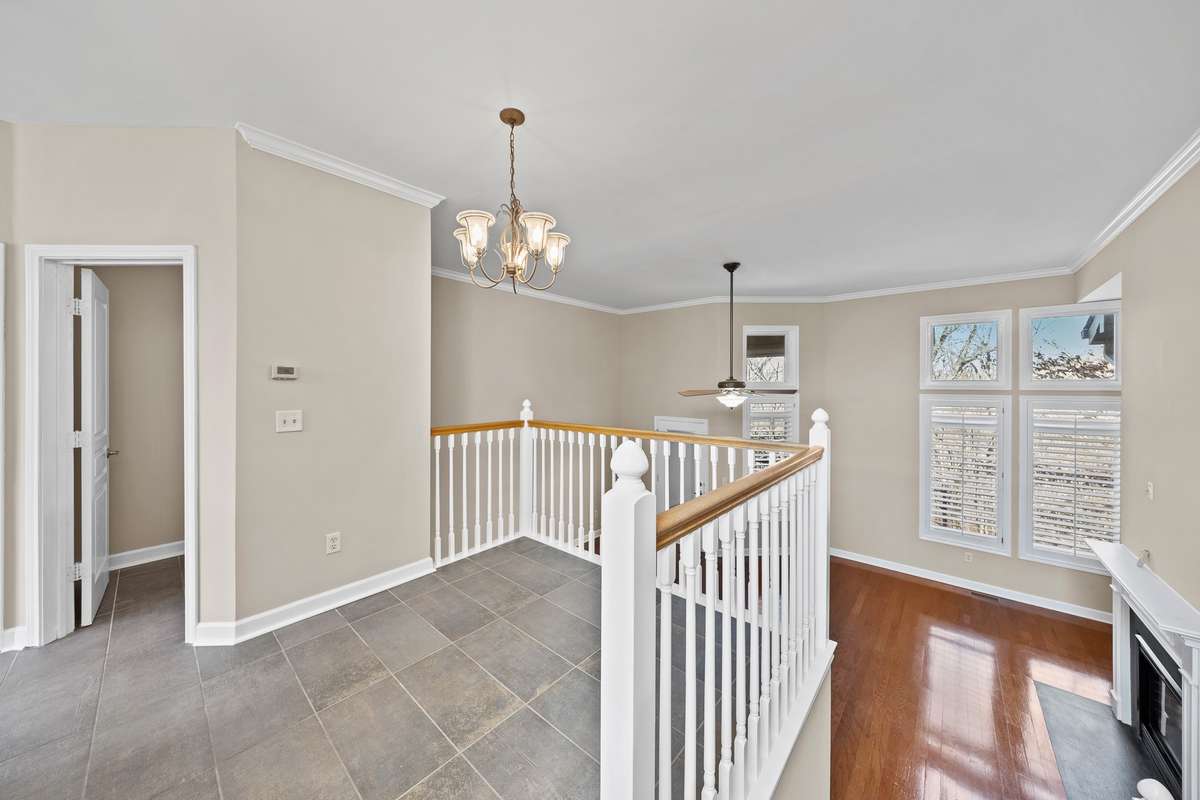 Dining area overlooks the living area. Updated tile flooring in the kitchen and guest bathroom.