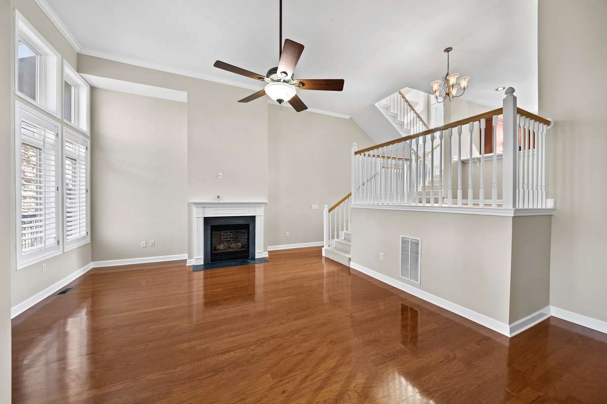 Refinished floors in the living area. Steps leading up to the dining area, guest bathroom, and utility closet.