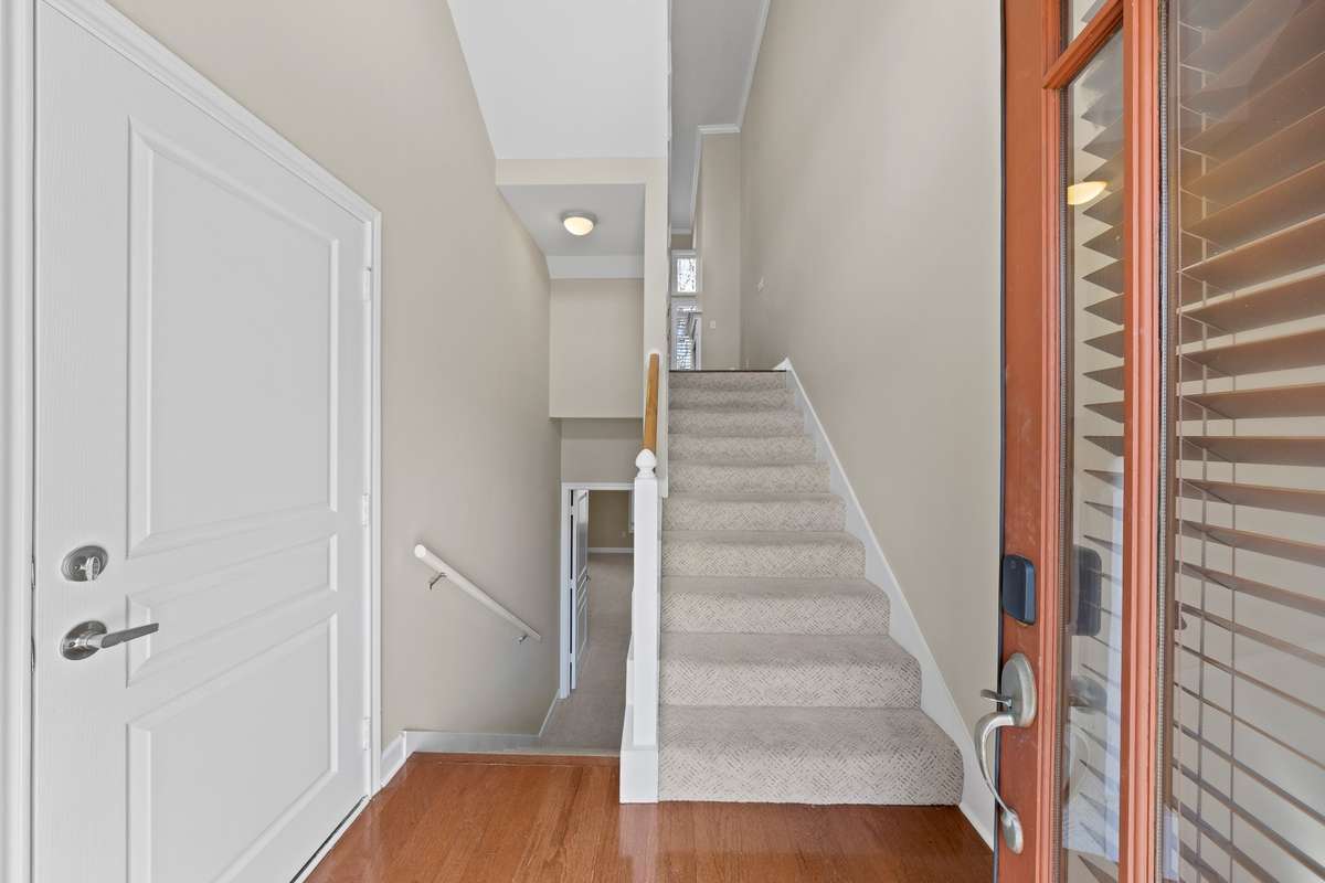 3 Floors, garage door to the left. Steps lead down to the lower level owner's suite. Steps lead up to the living and dining area.