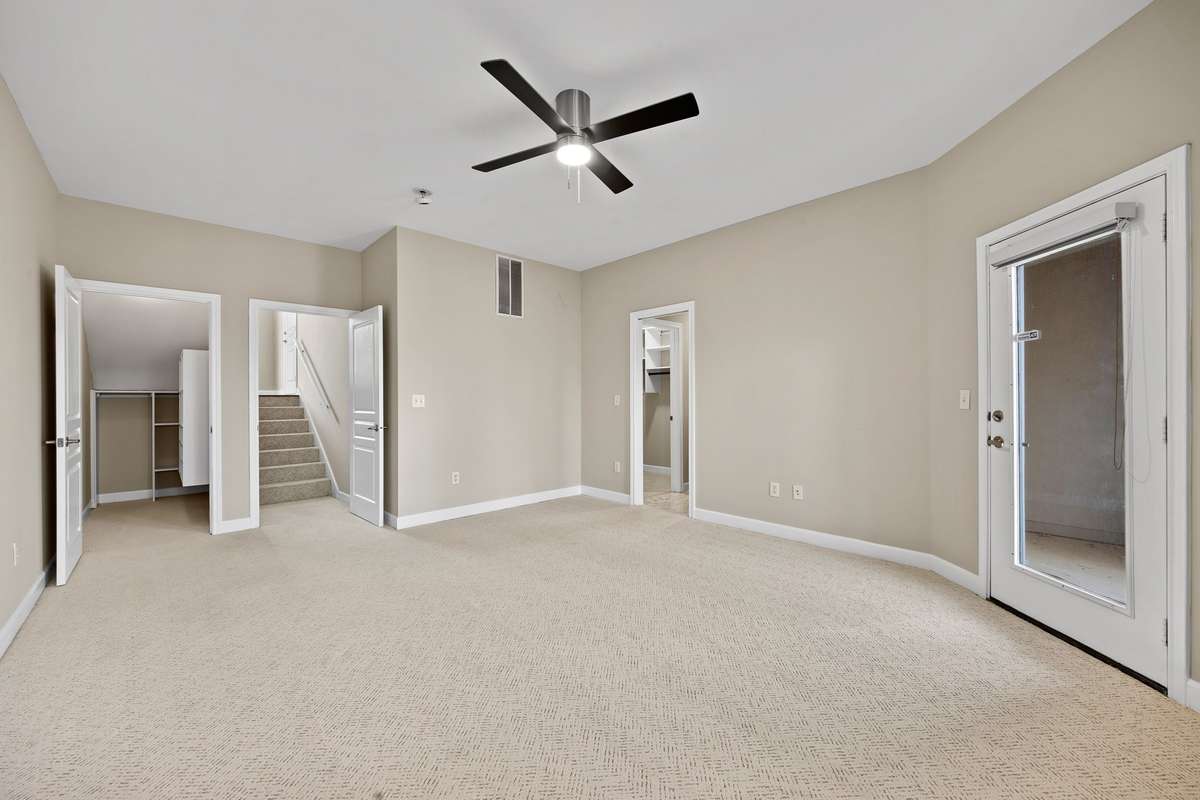 Downstairs Owner's Suite--Additional storage with new built-in shelving, new carpet, access to private patio and private bathroom with additional walk in closet.
