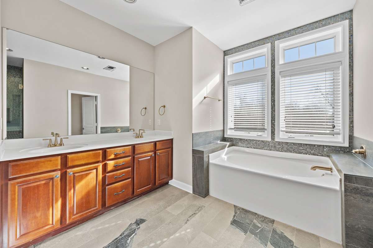 Double vanities, natural light, jacuzzi style tub (upstairs suite).