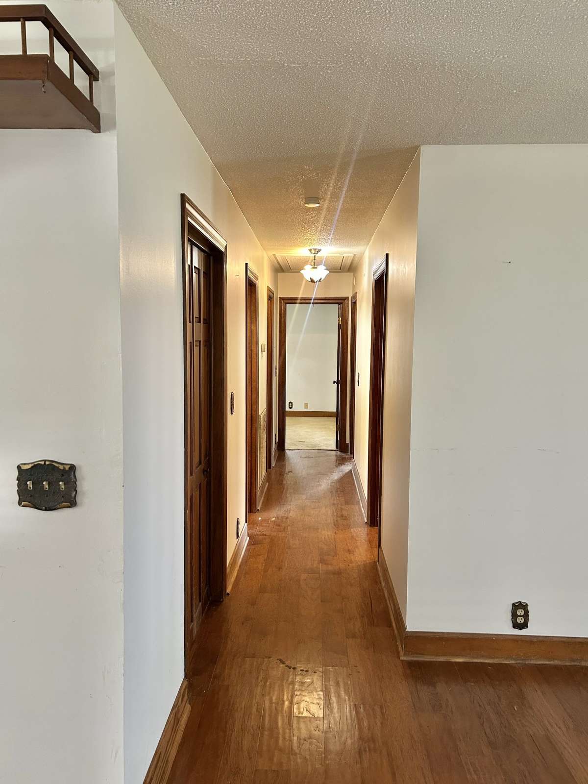Looking down the hall towards the three bedrooms, two baths, and the utility room.