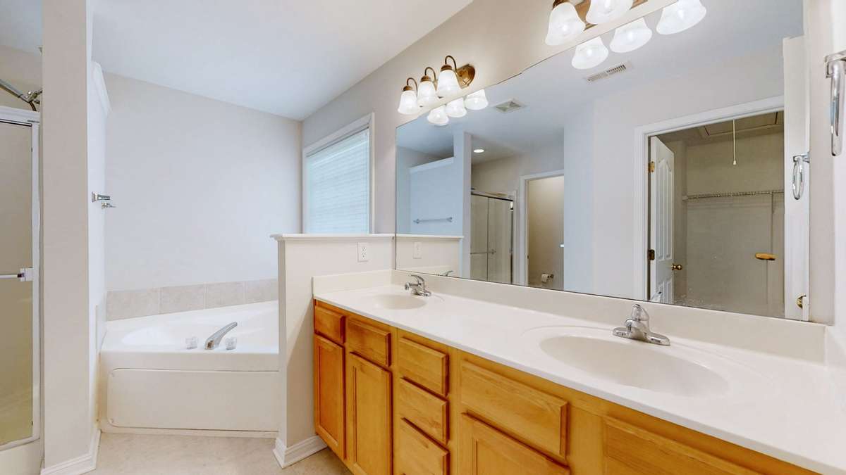 Large vanity with double sinks, garden tub and separate shower.  You'll love soaking in the garden tub.  Beautiful tile floors as well.