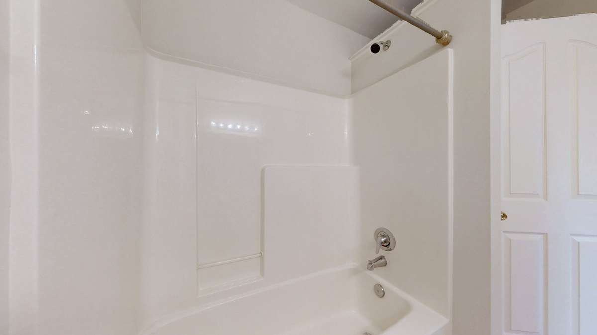 The guest bathroom has a shower/tub combo and a separate water closet just to the right of the tub.