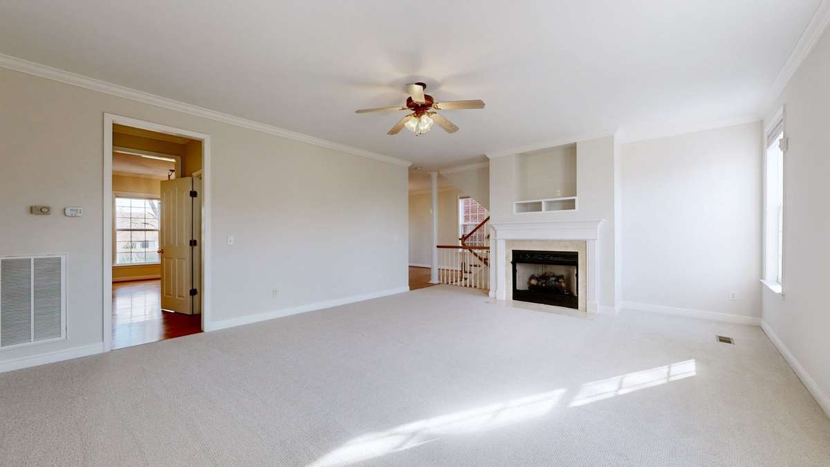 Passing thru from the kitchen into the very large living room.  Enjoy the ventless gas fireplace on the cold evenings. Looking to the right of the fireplace you can see into the dining room and stairway.