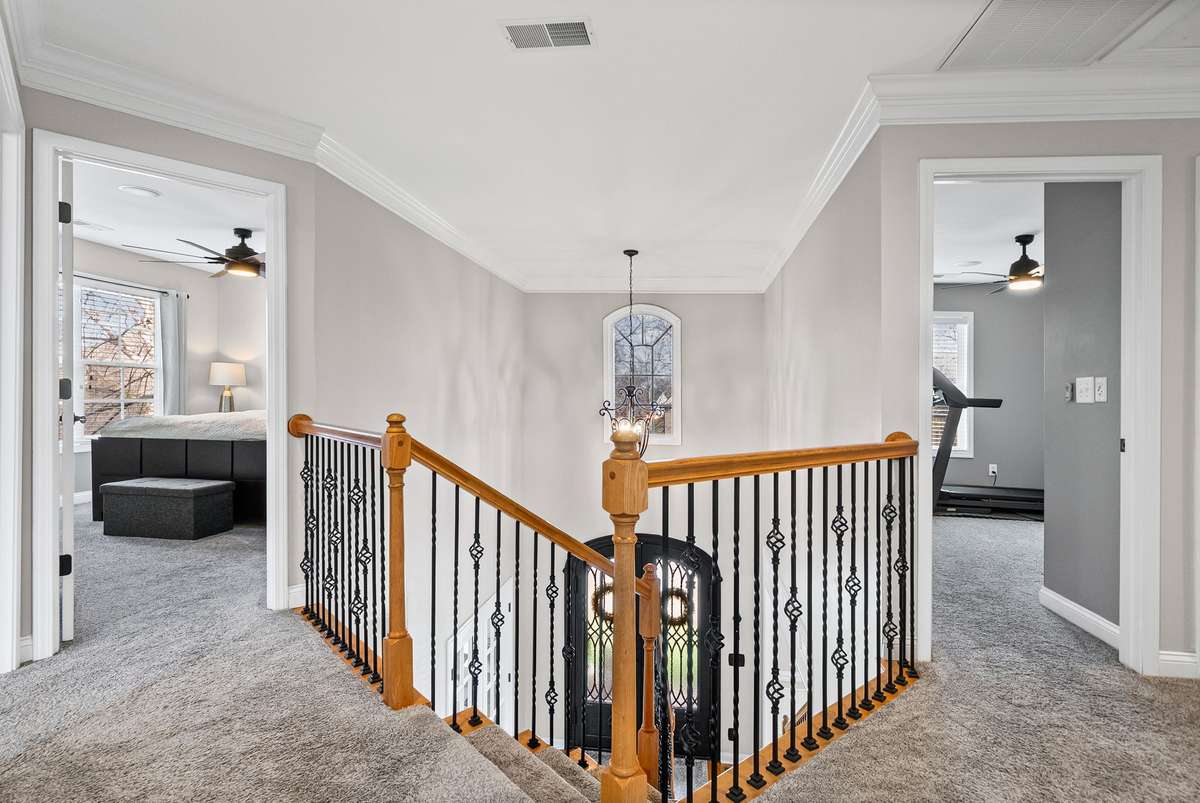 What a lovely landing at the top of the stairs leading you to 4 oversized bedrooms and a fabulous bonus room. Notice the iron railings, fresh paint everywhere and neutral colors.