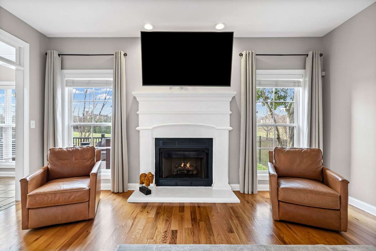 Warm and cozy evenings will be spectacular with your lovely centered fireplace with custom mantle. And enjoy reading a book and or watching TV while you oversee out your full length living room windows showcasing your beautiful backyard.
