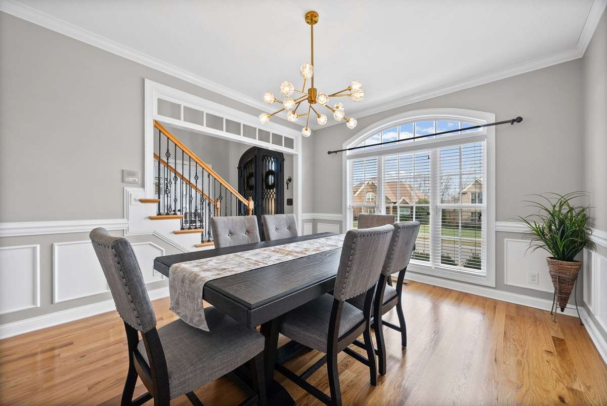 You will enjoy entertaining family and friends over the holidays and more in your stunning formal dining room, with full length windows for natural lighting, intricate wood details, transom overhead and more, and notice the lovely designer lighting.