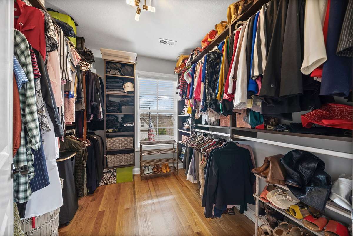 This is what a fabulous oversized walk in closet with natural lighting looks like.