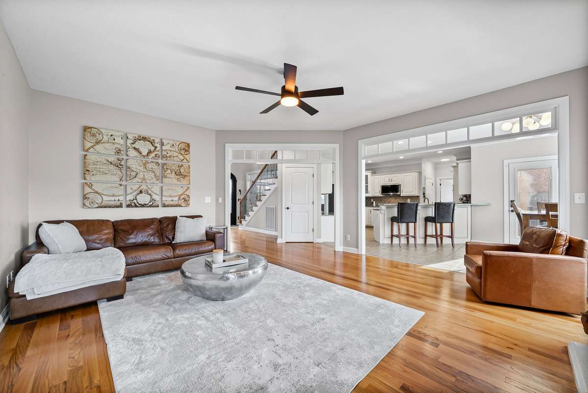 This second view of your gorgeous living room shows how it flows into your amazing eat in dining area, and notice the breathtaking hardwood flooring with abundant natural lighting gleaming down on them.