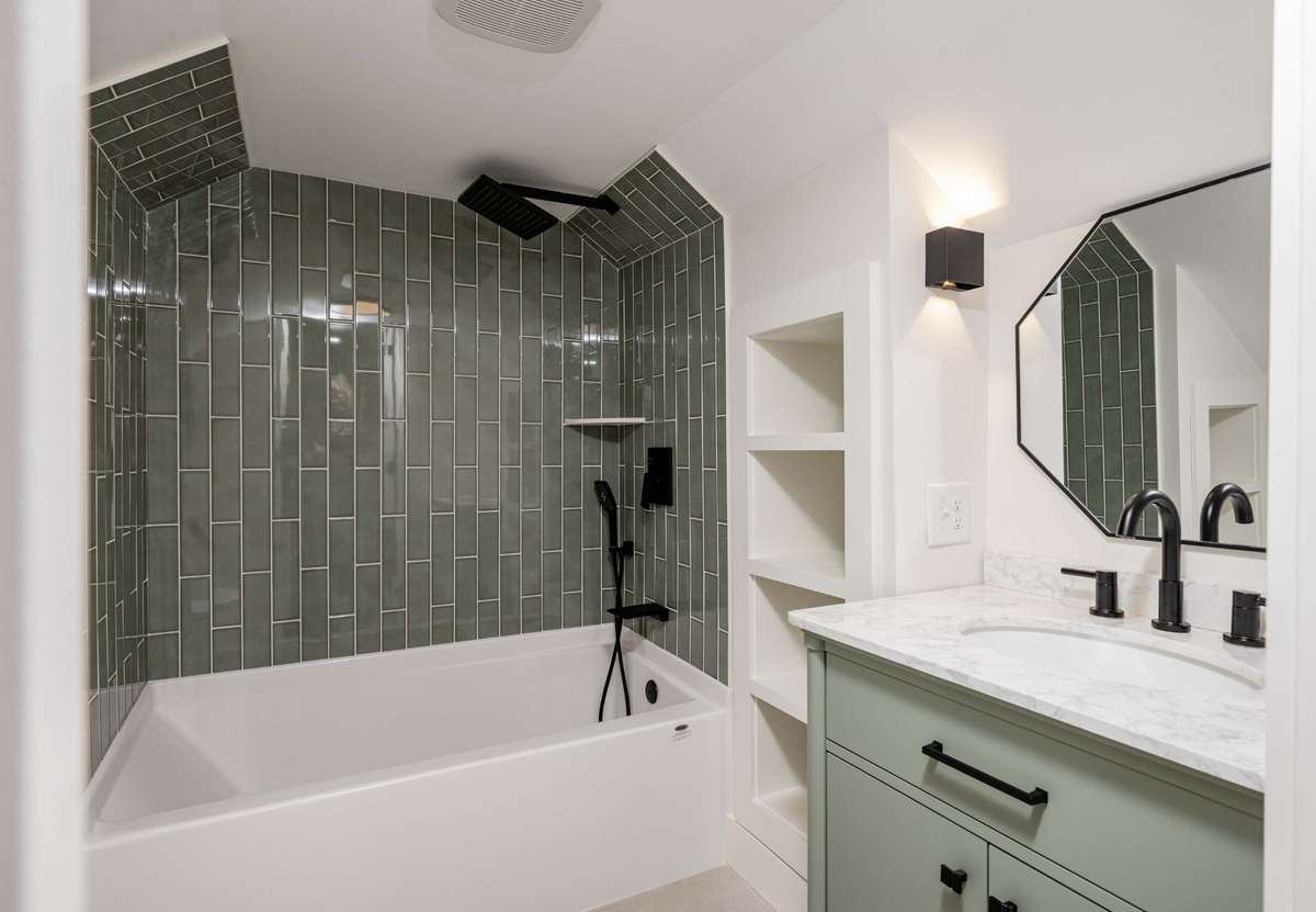 Upstairs full bath (#3) Hand laid tile shower and built in shelf.