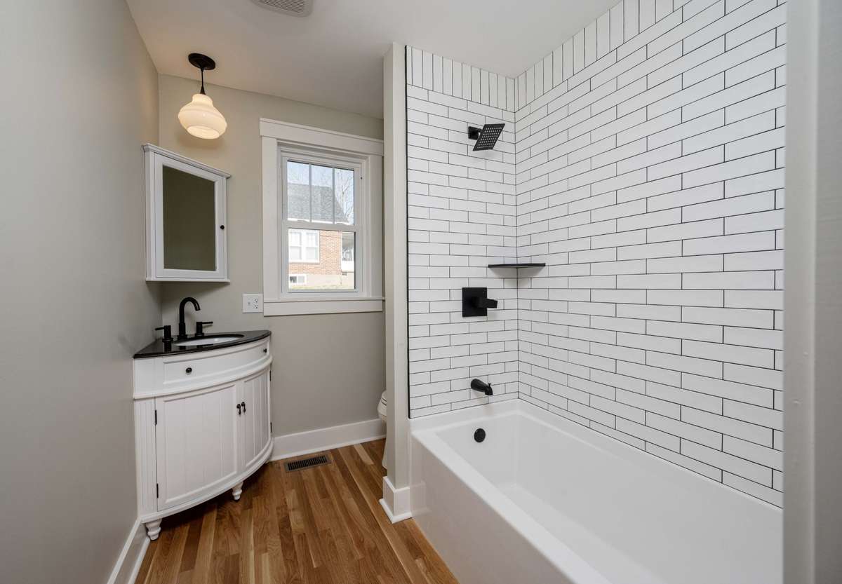 Guest bath (hallway) Cute corner sink and hand laid tile shower