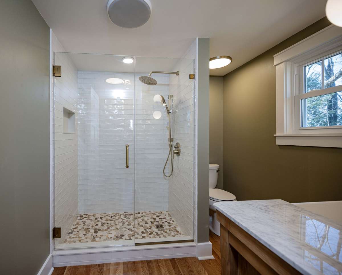 Glass shower doors and blue tooth speaker in the fan