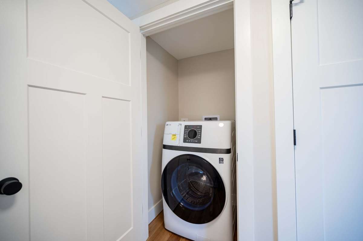 GE washer/dryer combo and the right door is a large pantry or flex storage closet