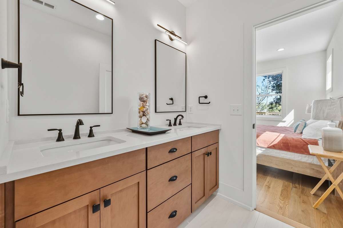 Primary Bathroom Vanity – Dual-sink vanity with wood cabinetry, quartz countertops, and modern fixtures.