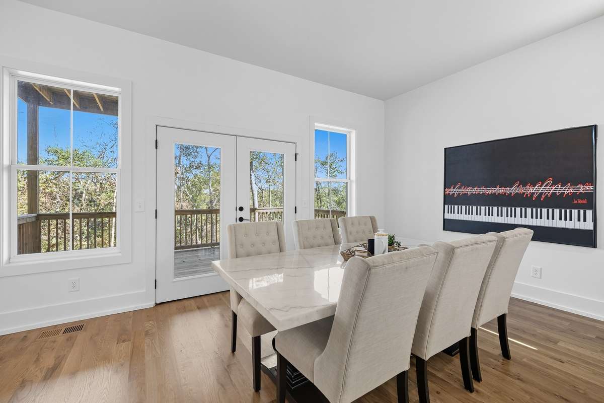 Dining space with modern lighting and a seamless flow into the living room, creating an ideal setting for entertaining.