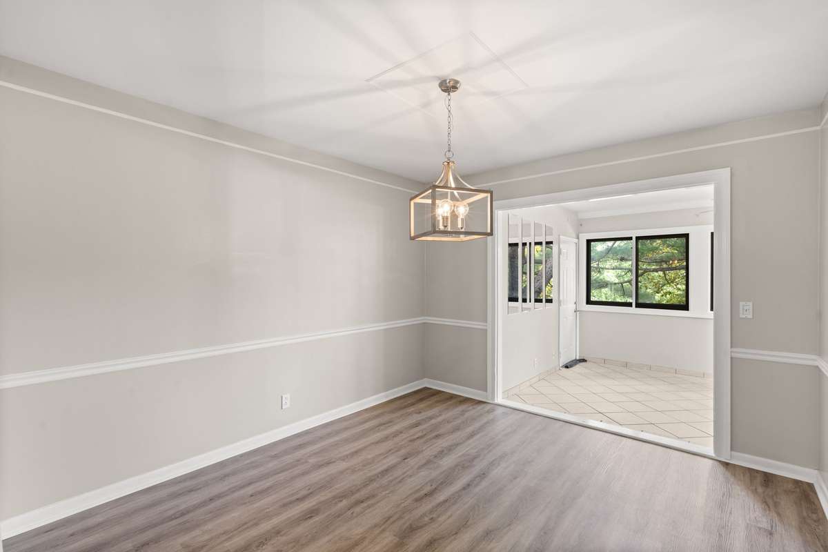 Separate Formal Dining Room includes new light fixture, LVP floors, fresh paint, chair rail and crown moulding. Opens to the large, bright Florida Room and Kitchen.