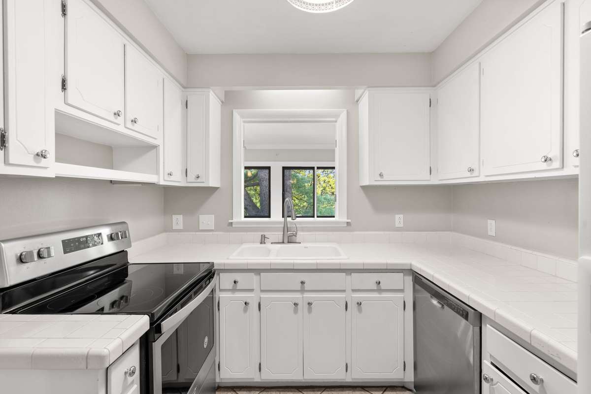 The updated Kitchen, situated just off of the Formal Dining Room, includes an eat-in nook, updated stainless steel stove/oven/dishwasher, new stackable washer/dryer unit, and lots of storage and countertop space. Opens to the Florida Room.
