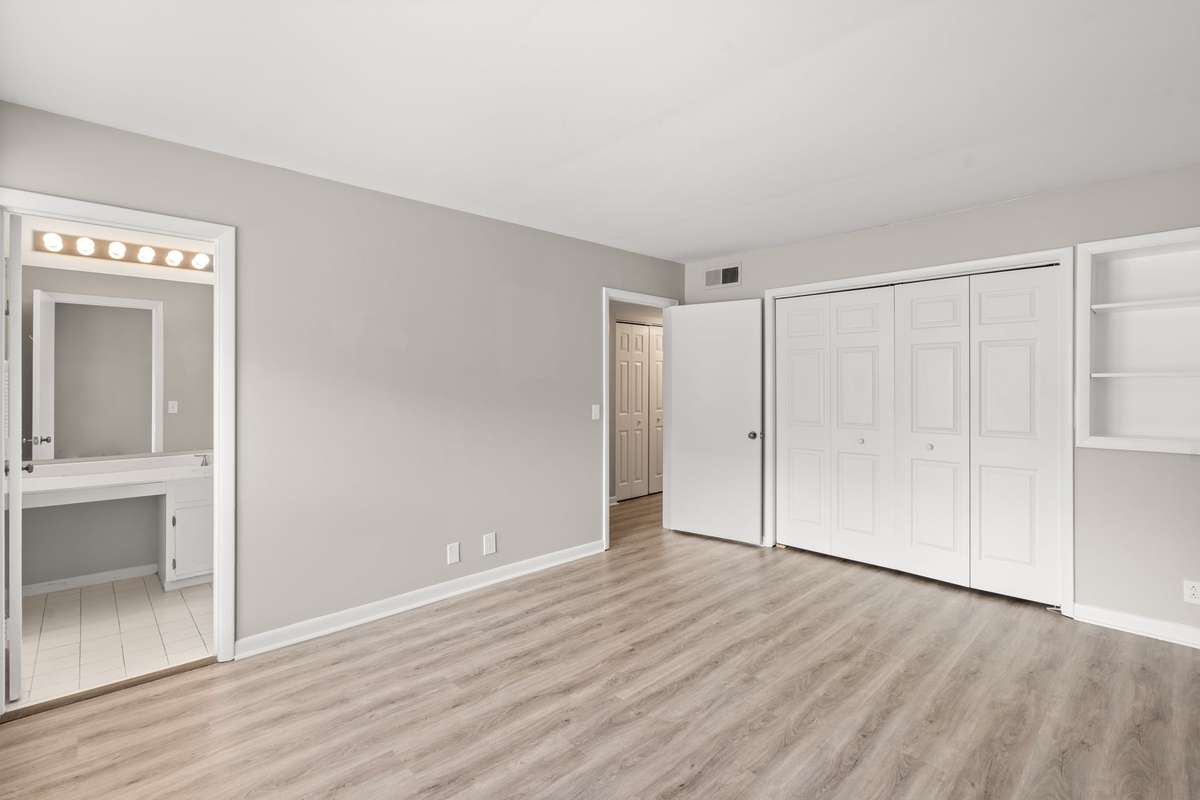 The first Bedroom offers lots of natural light, en suite Bathroom, luxury vinyl floors, fresh paint, and a spacious closet.