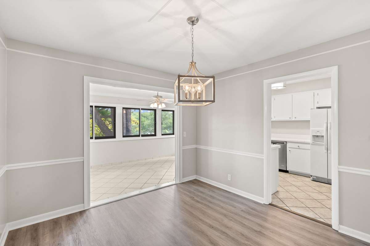 Separate Formal Dining Room includes new light fixture, LVP floors, fresh paint, chair rail and crown moulding. Opens to the large, bright Florida Room and Kitchen.