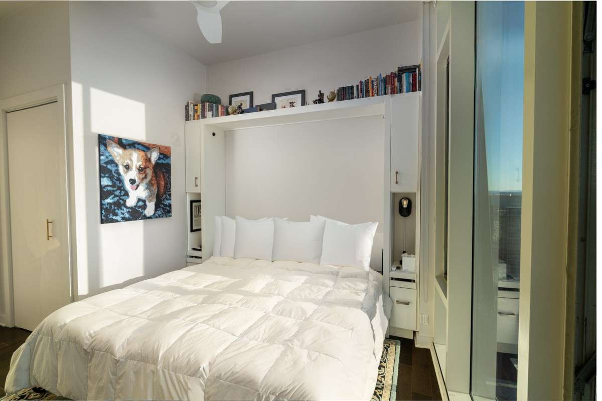 A stylish, multi-functional bedroom features a discreet Murphy bed that transforms the space with ease.