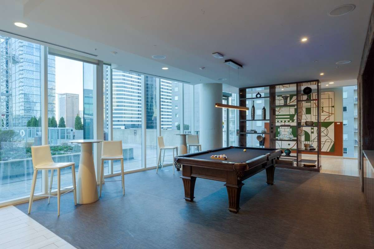 Gather, play, and unwind in this stylish game room featuring a pool table, bar seating, and a give-and-take library. A welcoming space designed for connection, casual fun, and making everyday memories with neighbors!