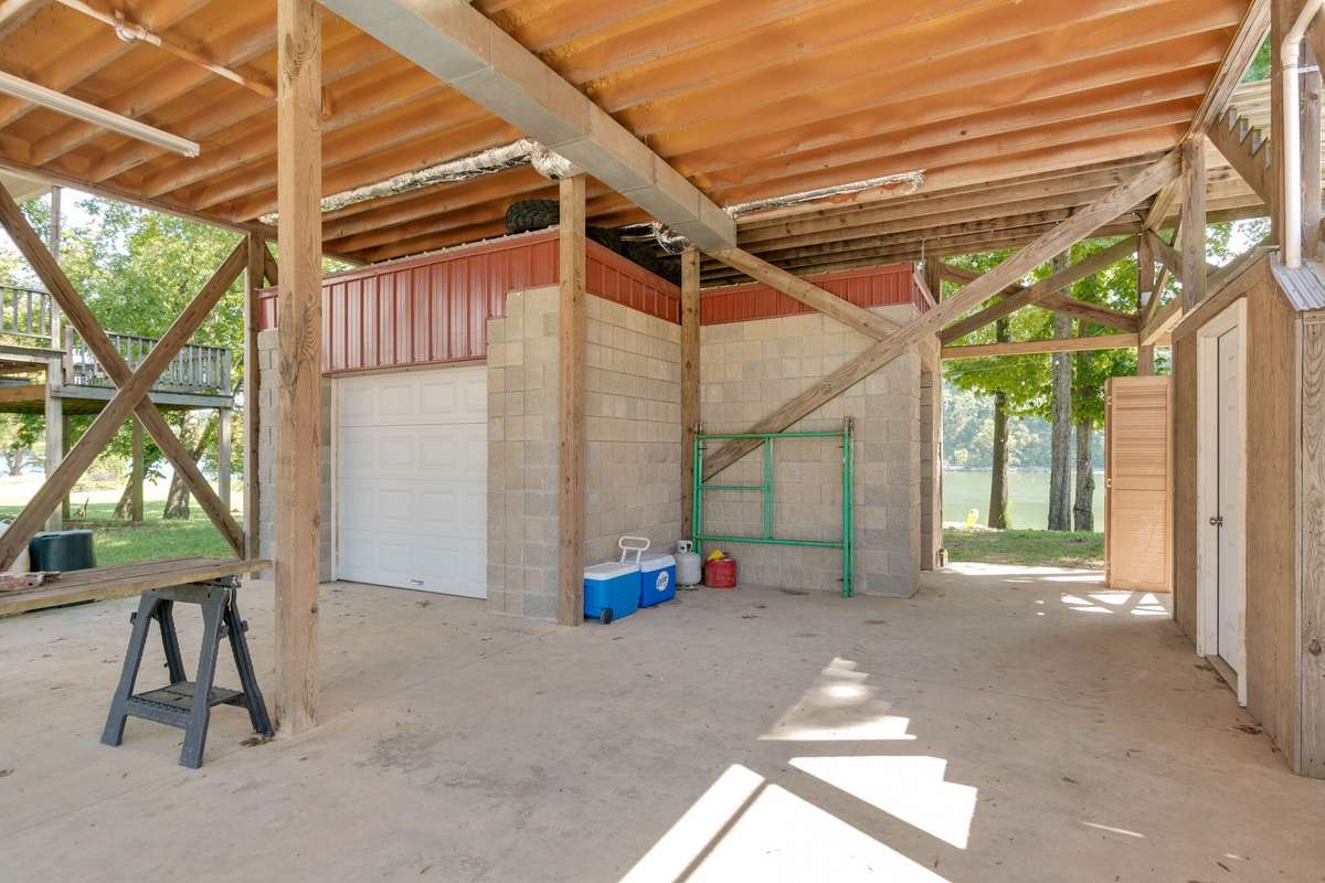 Lower level features parking, small garage, storage room, 1/2 bath, outdoor shower, and lift!