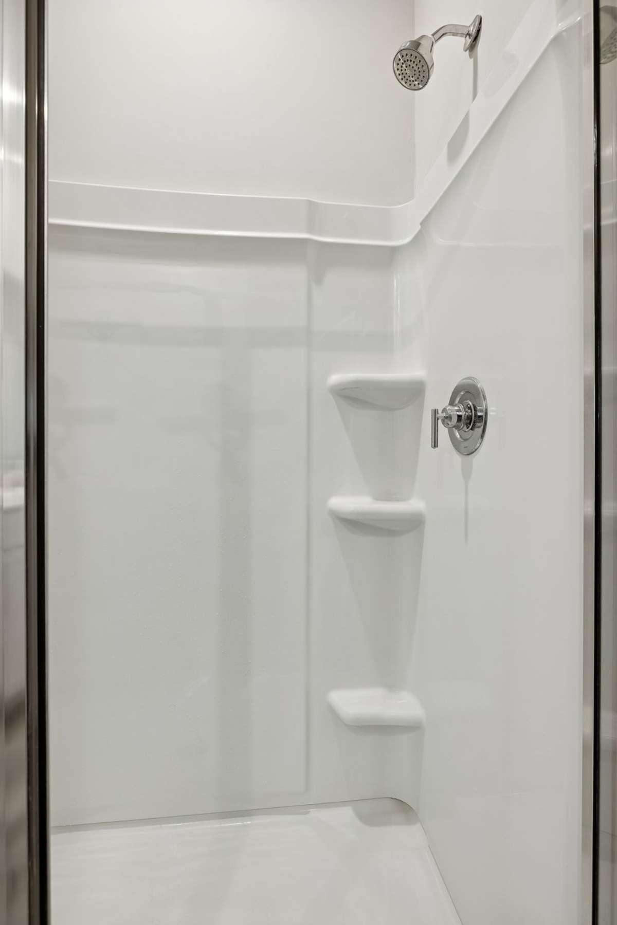 walk in shower with storage shelves