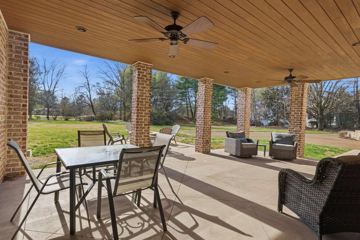 An additional exterior entertaining area under the screened in porch