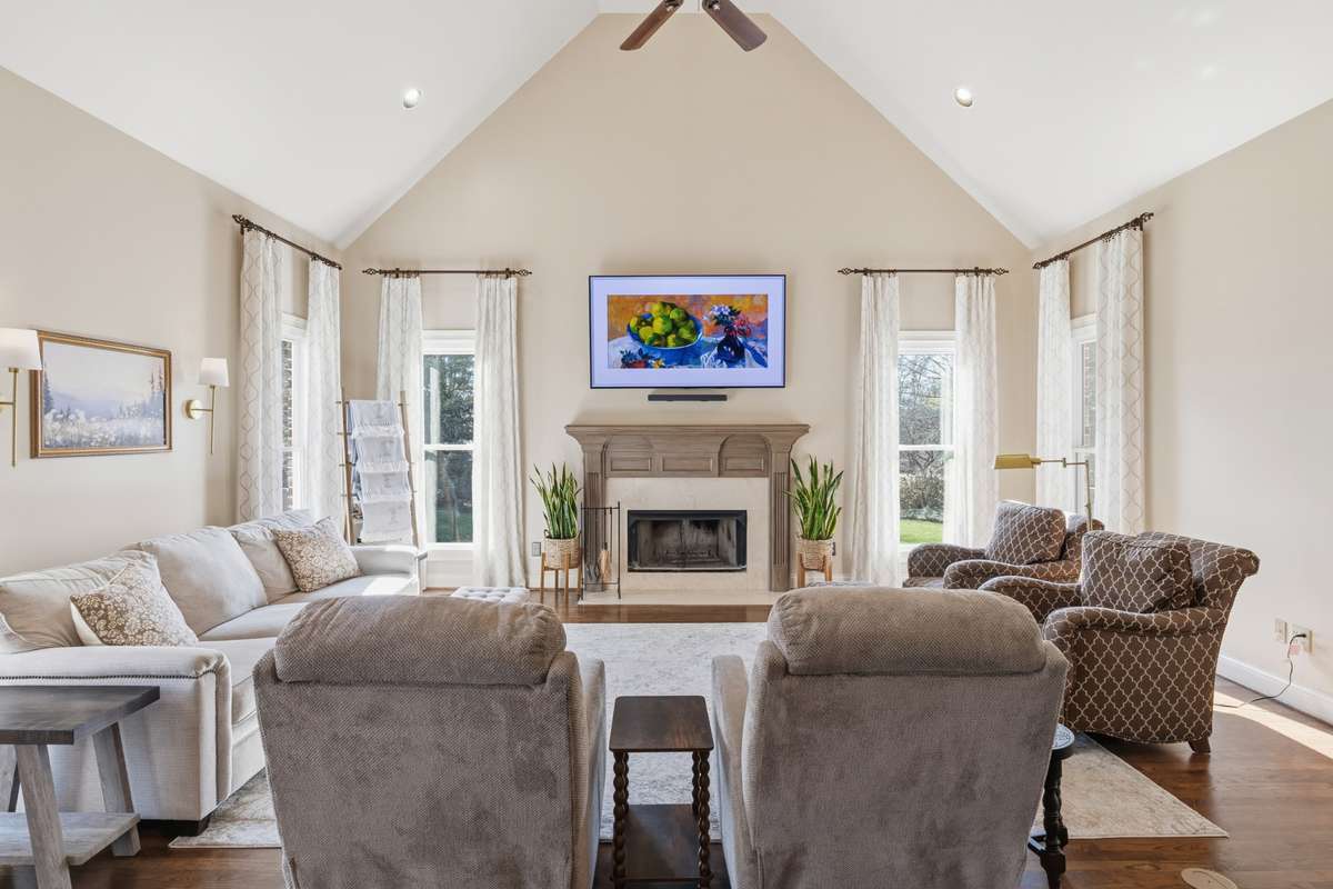 Located just off of the kitchen, this den features a vaulted ceiling and hardwood floors