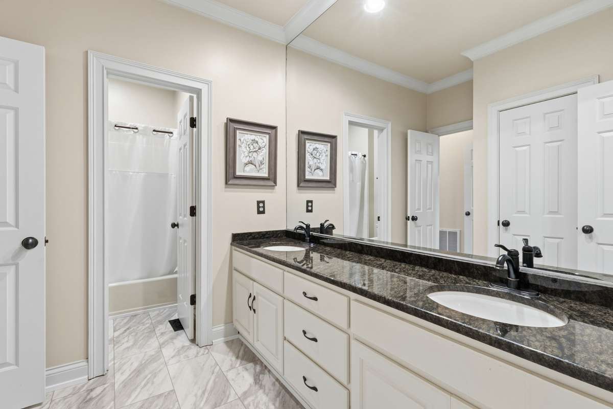 Main level hall bath with bedroom access to bedrooms #2 and #3.