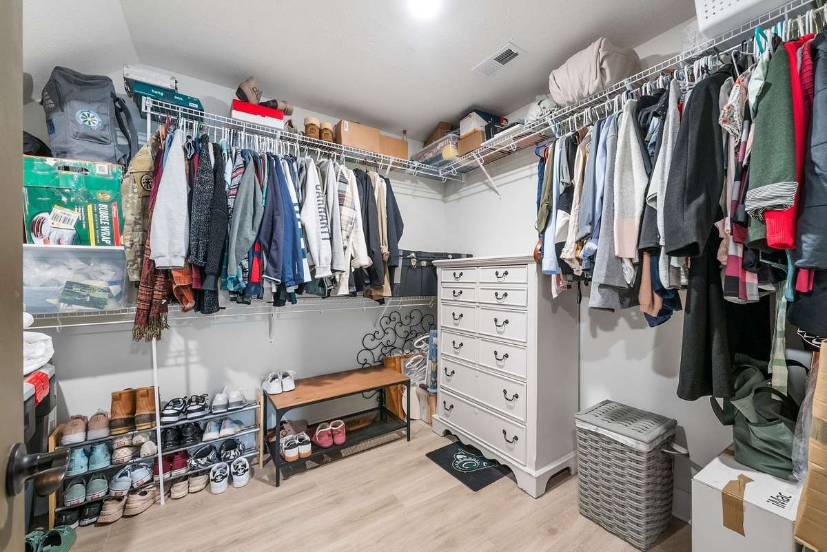 This walk in closet is so big, it could literally fit a queen bed.