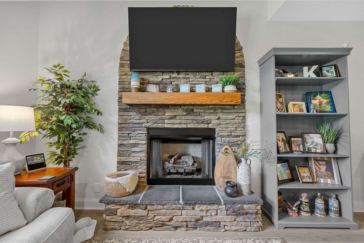 Cozy stone fireplace! The heart of the home with handcrafted floors.