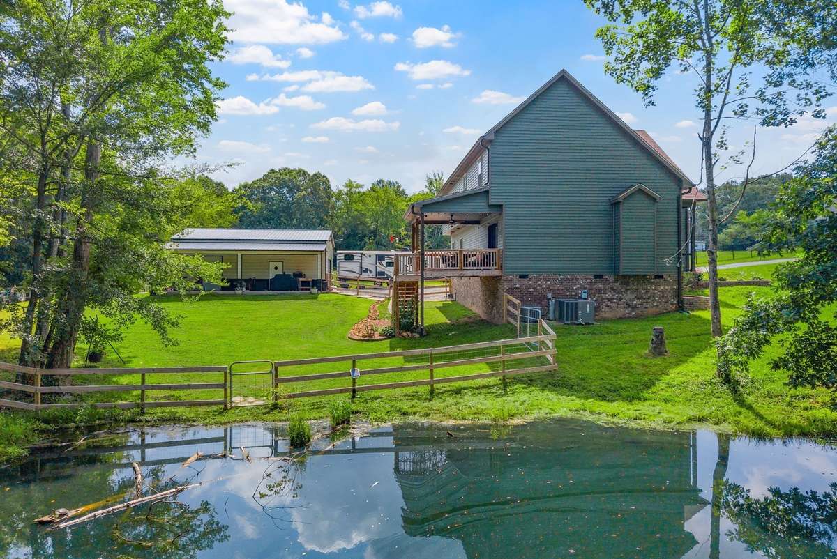 A long driveway leads to your peaceful 2.74 acre countryside retreat! ***Pond is designed for overflow to go to creek. Seller has not had any flooding issues. House sits up higher than pond.***