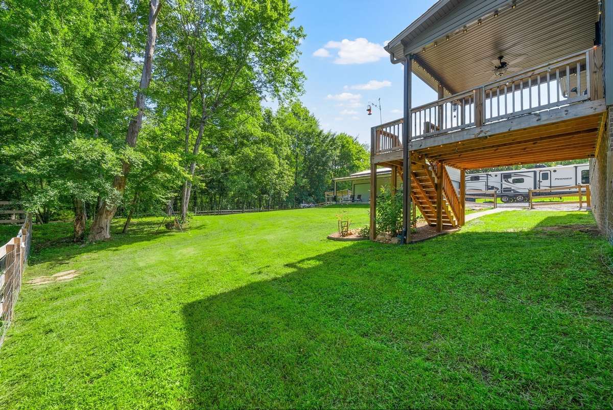 Expansive fenced in yard with space to live, play, and unwind.