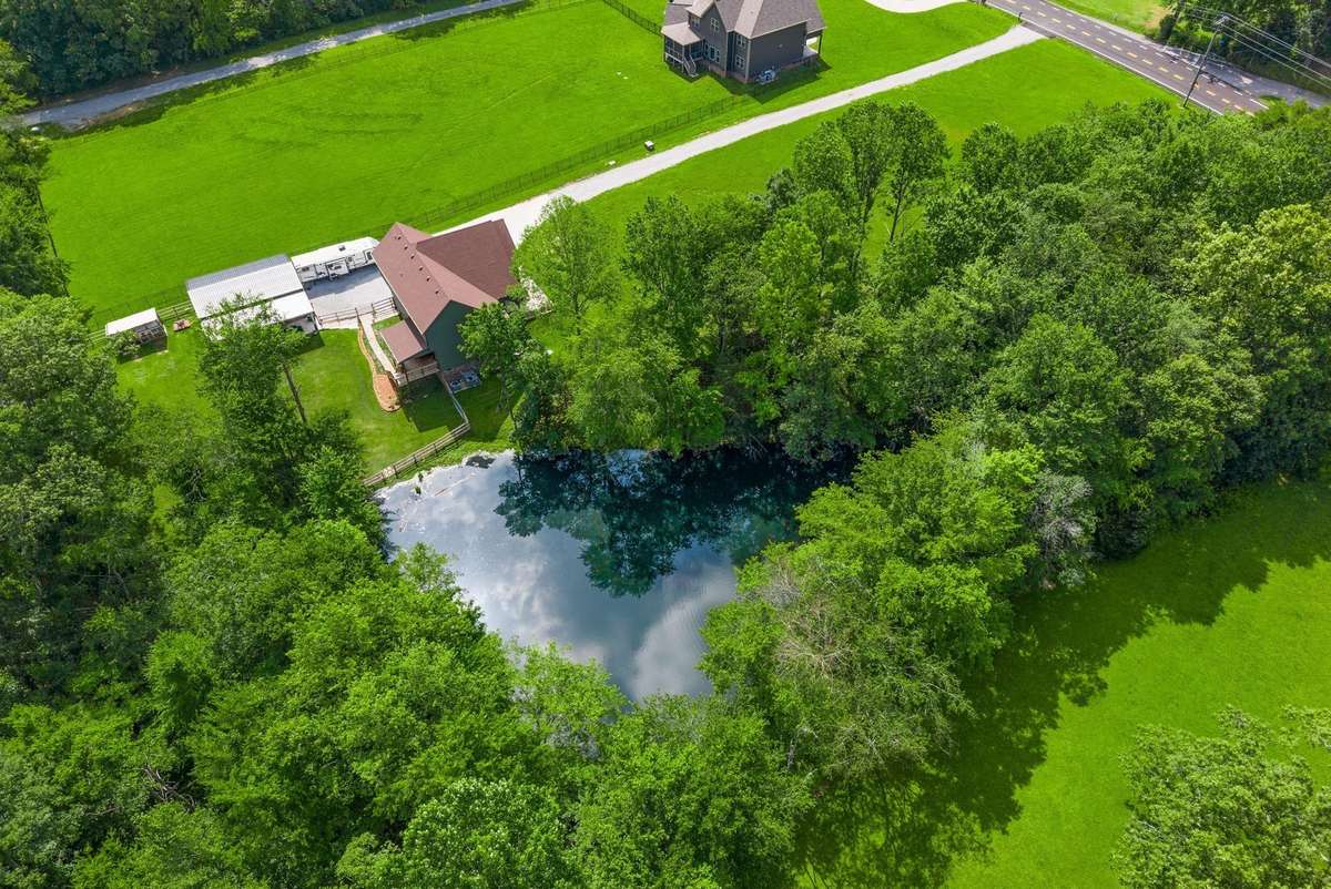 A long driveway leads to your peaceful 2.74 acre countryside retreat. ***Pond is designed for overflow to go to creek. Seller has not had any flooding issues. House sits up higher than pond.***