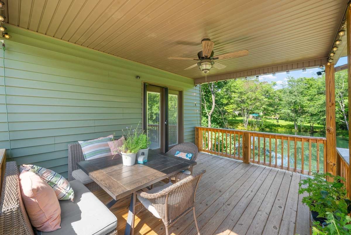 Covered deck that overlooks the pond and fenced in yard!