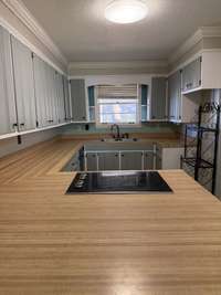 Lots of counter top and view of the cooktop stove.