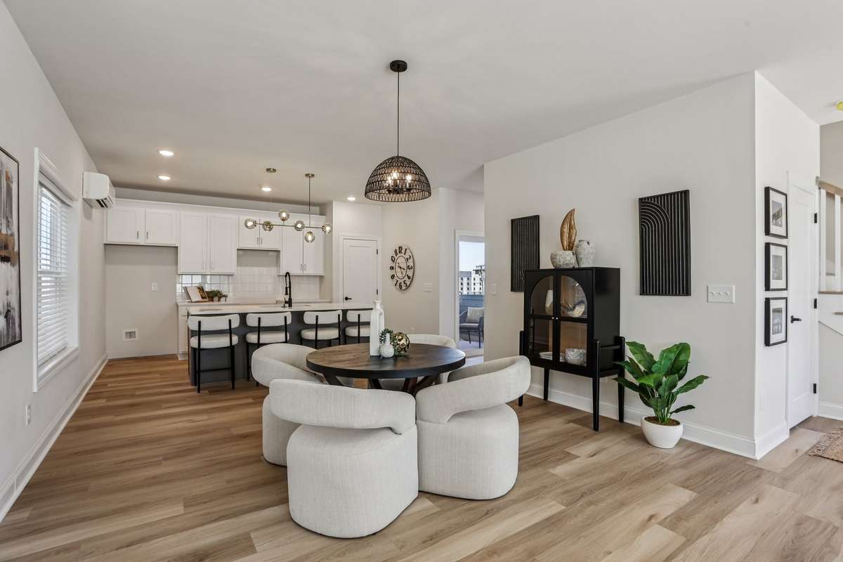 Dining area within the open-concept main level, positioned between the kitchen and living space for easy flow and everyday functionality.
