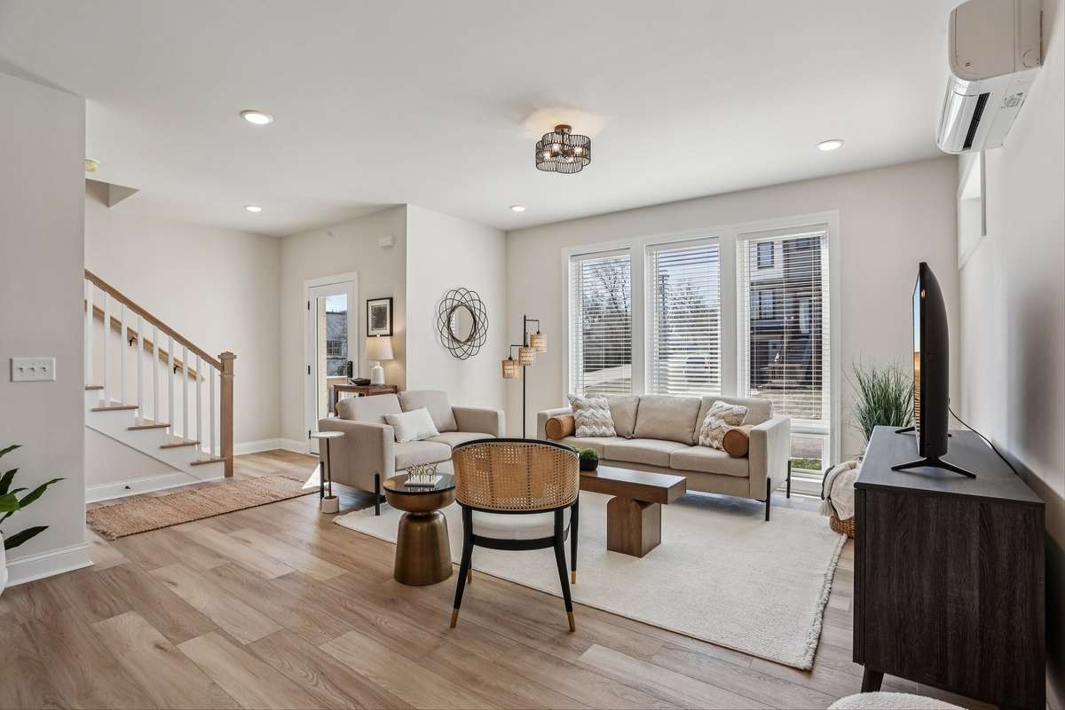 Light-filled open living space defined by oversized windows and seamless flow