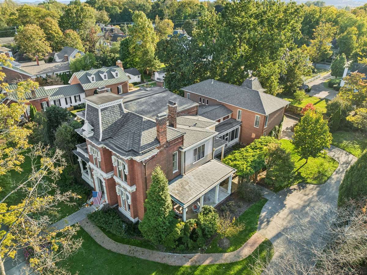 A striking example of Second French Empire French Victorian architecture, the home is distinguished by its mansard roof, segmental arched openings, bracketed eaves with pavilions, central tower, and an extraordinary cornice.